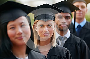 She believed she could, so she did. a group of young college graduates standing in a row.