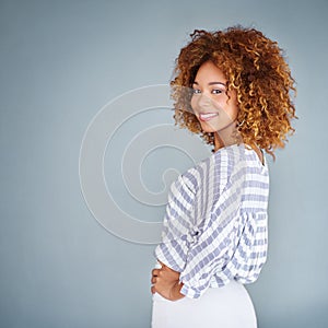 She believed she could, so she did. Studio shot of a young businesswoman against a gray background.