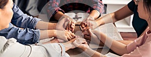 Believer hand praying together on bible book while holding hand. Burgeoning