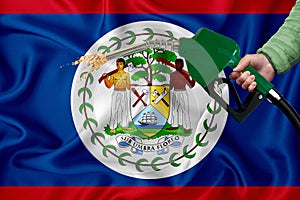 BELIZE flag Close-up shot on waving background texture with Fuel pump nozzle in hand. The concept of design solutions. 3d