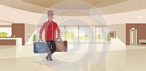 Bell boy carrying suitcases hotel service concept bellman holding luggage male worker in uniform modern reception area