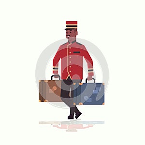Bell boy carrying suitcases service concept african american bellman holding luggage male hotel worker in uniform full