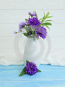 Bell, chrysanthemum vase elegance on a wooden background