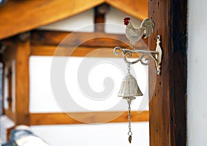 Bell with cock on the door