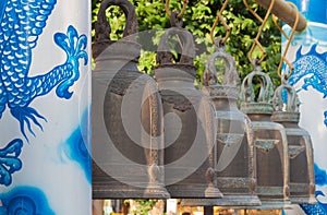 Bell with dragon pillar in belfry at thai temple