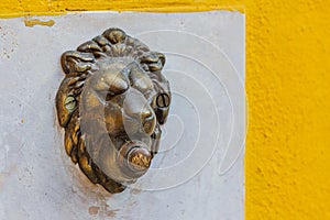 bell in the form of a metal sculpture of a lion's head