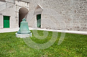 Bell, grass, doors and church