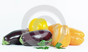 bell pepper,eggplants and sprigs of parsley on a white background.