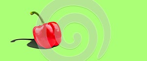 Bell pepper on a green background. Hard shadow. Copy space. Vegetables