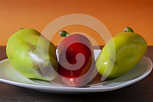 Bell pepper in a plate on an orange background