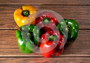 Bell pepper variety of color on a wooden board