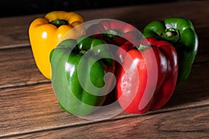 Bell pepper variety of color on a wooden board