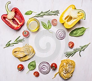 Bell peppers, oil, rosemary, cherry tomatoes and other ingredients for cooking vegetarian pasta, lined frame wooden rustic back