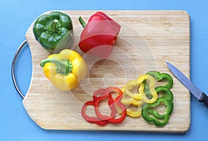 Bell peppers and slices of bell peppers on a cutting board