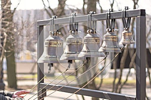 The bell-ringers hands hold the ropes from the church bells photo