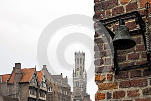 Bell at the Rozenhoedkaai canal in Bruges with the Belfry in the background.