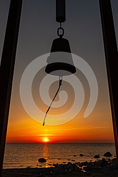 BellÂ´s silhouette moving in wind during sunset in sea