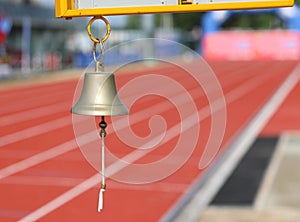 bell to indicate to the athletes the last lap of the race