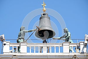 The bell on top of an ancient Clock Tower Torre dell`Orologio in the Piazza San Marco, Venice photo