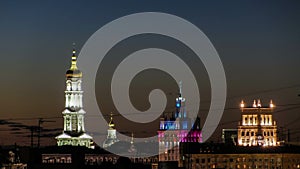 The bell tower of the Assumption Cathedral Uspenskiy Sobor, City council and house with a spire night timelapse in