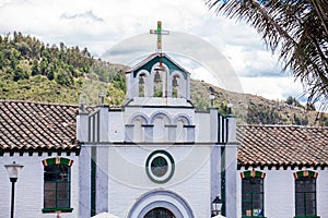 Bell tower of the chapel dedicated to Divine Mercy in the small town of Mongui in Colombia photo