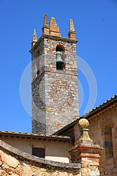 The bell tower of the Church of Santa Maria Assunta in Piazza Roma in Monteriggioni photo