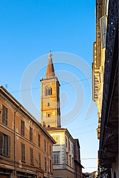 bell tower of church and street in Pavia at sunset