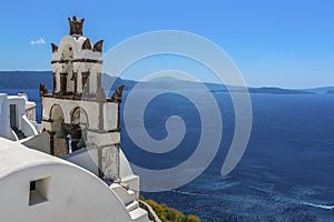 The bell tower of a church in the village of Oia, Santorini overlooks the caldera