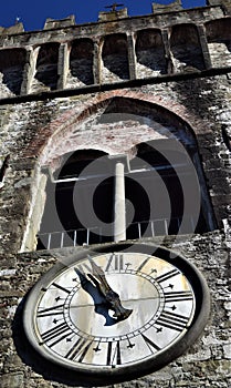 Bell tower and clock under the mullioned window in Ghivizzano in the province of Lucca, one of the beautiful and ancient medieval