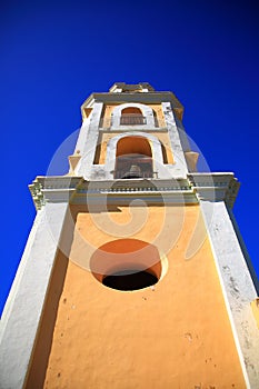 The bell tower of the Convento de San Francisco de AsÃ­s against the blue sky. Trinidad city, Cuba