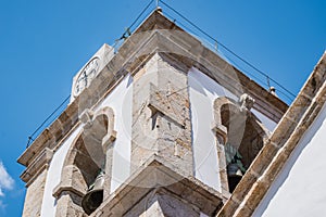 Perspective of church bell tower with stone clock and sundial, PedrogÃÂ£o Pequeno PORTUGAL photo