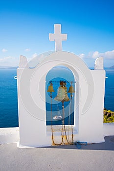 Bell tower of an orthodox church at Santorini, Greece. Honeymoon summer aegean cycladic background.