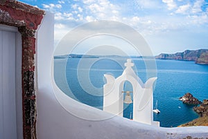 Bell tower of an orthodox church at Santorini, Greece. Honeymoon summer aegean cycladic background.