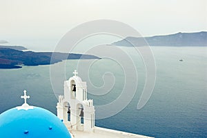 Bell tower of an orthodox church at Santorini, Greece. Honeymoon summer aegean cycladic background.