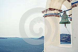 Bell tower of an orthodox church at Santorini, Greece. Honeymoon summer aegean cycladic background.