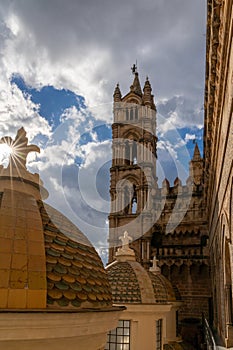 bell tower and rooftop with cupolas of the Palermo Cathedral with a sunburst