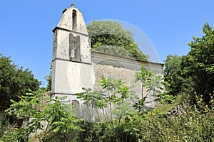 The bell tower of Saint Spiridon Church in the desert mountain village of The Old Perithia Ano Palea Perithia, Corfu Island, Gre