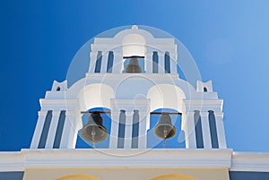 Bell tower of small church in Oia, Santorini island, Greece