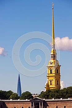 The bell tower with the spire of the Peter and Paul Cathedral next to the Gazprom tower.