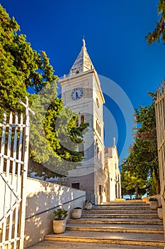 Bell tower of St George Church in Primosten town, a popular tour