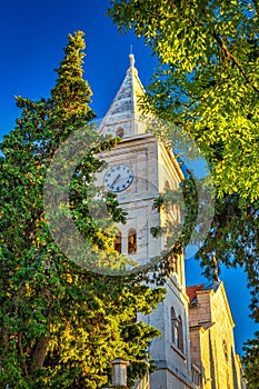 Bell tower of St George Church in Primosten town, a popular tour