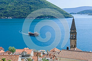 The bell tower of St Nicholas church in Perast and Verige is the strait of Boka Kotorska in the background. Montenegro photo