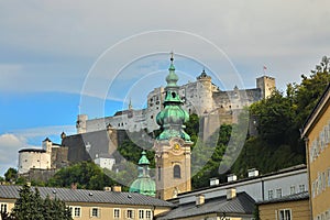 The Bell Tower of St Peter Collegiate Church with Hohensalzburg Fortress Festung Hohensalzburg at the background, Salzburg, Aust