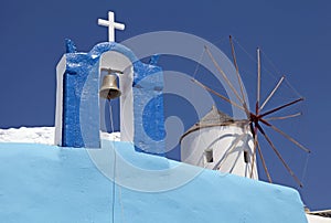 Bell tower and windmill in Oia village, Santorini, Greece