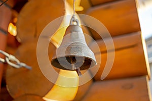 Bell on traditional russian village house made of logs. Authentic landscape. Soft focus