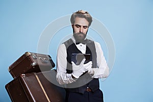 Bellboy with gloves reading reservations photo