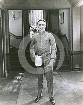 Bellboy holding pitcher