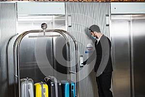 bellboy in medical mask standing near