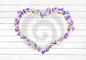 Bellflowers and meadow flowers as a heart frame