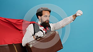 Bellhop acting as superhuman with cape photo